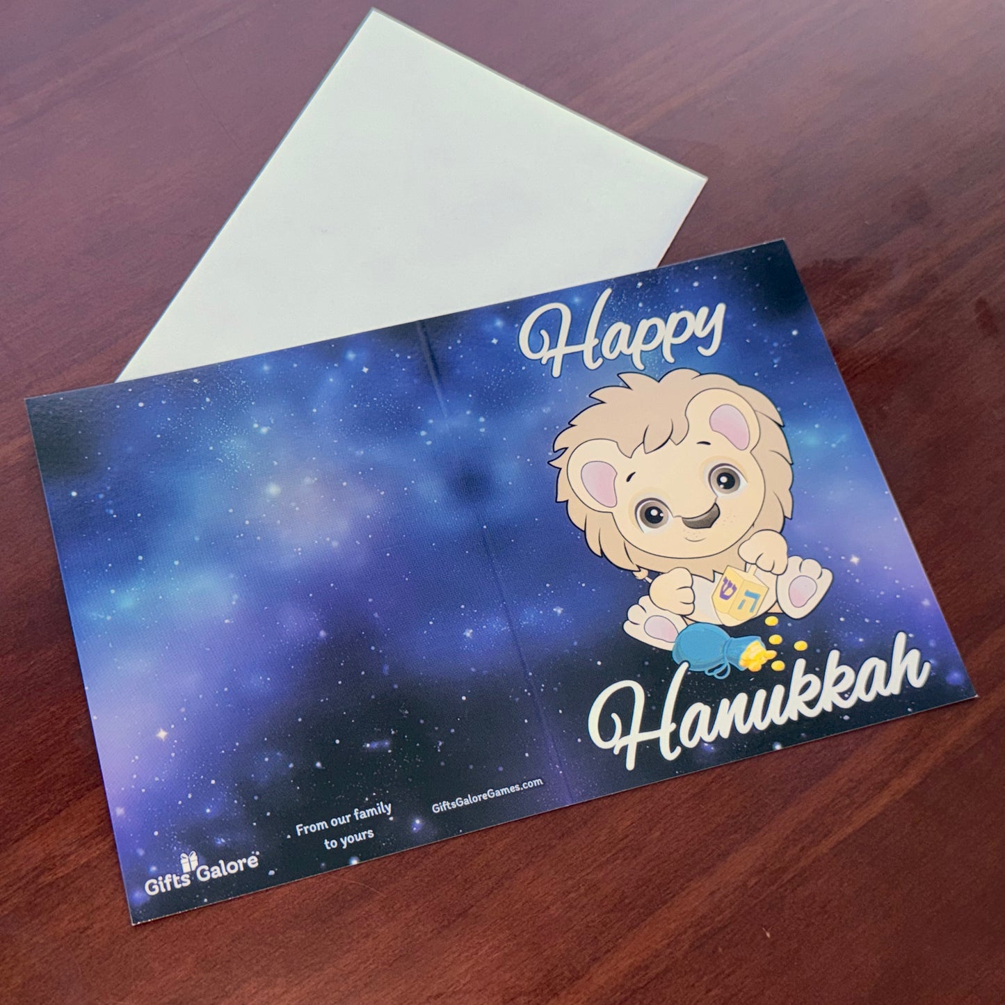 Greeting card: Lion with dreidel and gelt